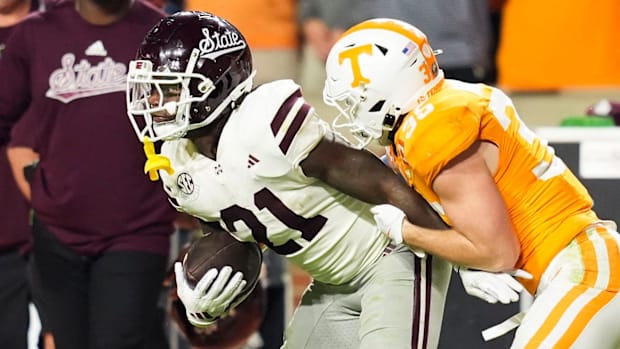Bulldogs running back Davon Booth tries to escape a tackle by Tennessee Volunteers defensive back Will Brooks