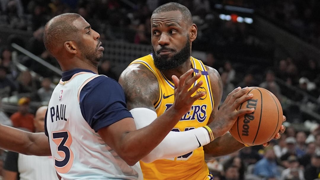 Los Angeles Lakers forward LeBron James (23) dribbles against San Antonio Spurs guard Chris Paul (3) in the second half at Frost Bank Center.