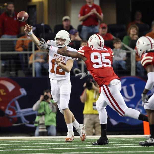 Texas Longhorns quarterback Colt McCoy (12) throws while under pressure from Nebraska Cornhuskers defensive end Pierre Allen 