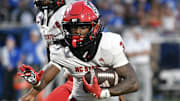 Sep 20, 2025; Durham, North Carolina, USA; North Carolina State Wolfpack running back Hollywood Smothers (3) runs the ball against the Duke Blue Devils during the fourth quarter at Wallace Wade Stadium. Mandatory Credit: Zachary Taft-Imagn Images