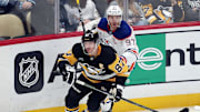 Jan 9, 2025; Pittsburgh, Pennsylvania, USA;  Pittsburgh Penguins center Sidney Crosby (87) and Edmonton Oilers center Connor McDavid (97) chase the puck during the third period at PPG Paints Arena. Mandatory Credit: Charles LeClaire-Imagn Images