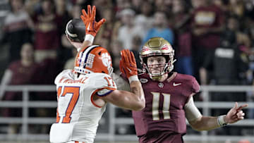 Oct 5, 2024; Tallahassee, Florida, USA; Florida State Seminoles quarterback Brock Glenn (11) throws the ball as he is pressured by Clemson Tigers linebacker Wade Woodaz (17) during the second half at Doak S. Campbell Stadium. Mandatory Credit: Melina Myers-Imagn Images