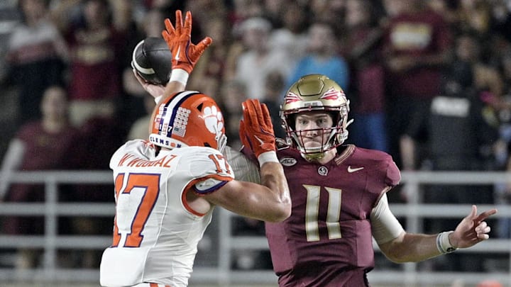 Oct 5, 2024; Tallahassee, Florida, USA; Florida State Seminoles quarterback Brock Glenn (11) throws the ball as he is pressured by Clemson Tigers linebacker Wade Woodaz (17) during the second half at Doak S. Campbell Stadium. Mandatory Credit: Melina Myers-Imagn Images