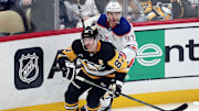 Jan 9, 2025; Pittsburgh, Pennsylvania, USA;  Pittsburgh Penguins center Sidney Crosby (87) and Edmonton Oilers center Connor McDavid (97) chase the puck during the third period at PPG Paints Arena. Mandatory Credit: Charles LeClaire-Imagn Images