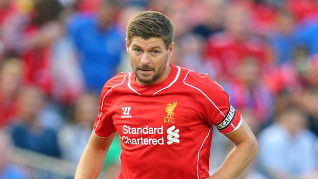 Liverpool FC midfielder Steven Gerrard (8) controls the ball against Manchester City FC during the first half of a game.