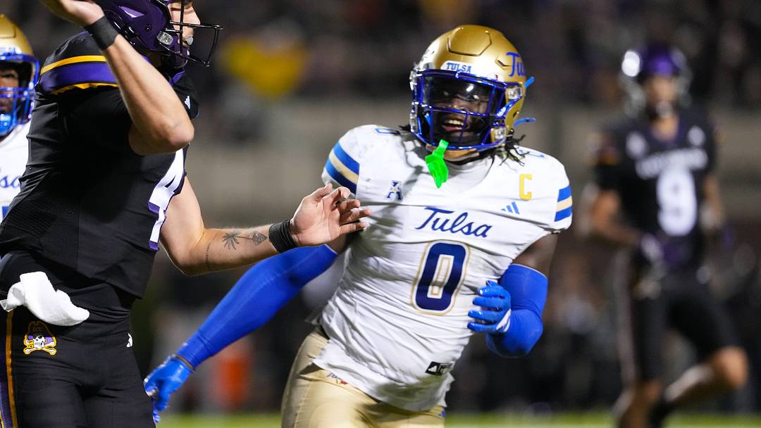 East Carolina Pirates quarterback Katin Houser (4) throws the ball against Tulsa Golden Hurricane linebacker Ray Coney (0) during the first half at Dowdy-Ficklen Stadium. East Carolina Pirates quarterback Katin Houser (4) throws the ball against Tulsa Golden Hurricane linebacker Ray Coney (0) during the first half at Dowdy-Ficklen Stadium.