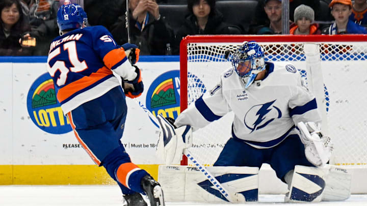 Dec 13, 2025; Elmont, New York, USA; New York Islanders left wing Emil Heineman (51) scores the game winning goal past Tampa Bay Lightning goaltender Jonas Johansson (31) during shoot outs at UBS Arena. Mandatory Credit: Dennis Schneidler-Imagn Images