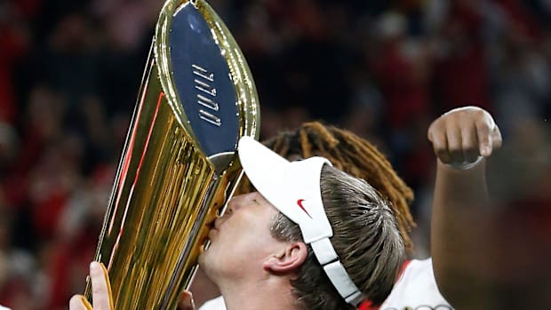 Georgia coach Kirby Smart kisses the national championship trophy.