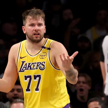 Mar 10, 2025; Brooklyn, New York, USA; Los Angeles Lakers guard Luka Doncic (77) reacts towards referee Ray Acosta (54) during the fourth quarter against the Brooklyn Nets at Barclays Center. Mandatory Credit: Brad Penner-Imagn Images