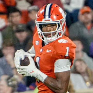 Nov 8, 2025; Clemson, South Carolina, USA; Clemson Tigers wide receiver T.J. Moore (1) runs after a catch near Florida State Seminoles defensive lineman Jayson Jenkins (97) during the second quarter at Memorial Stadium. Mandatory Credit: Ken Ruinard - GREENVILLE NEWS-USA TODAY Network via Imagn Images