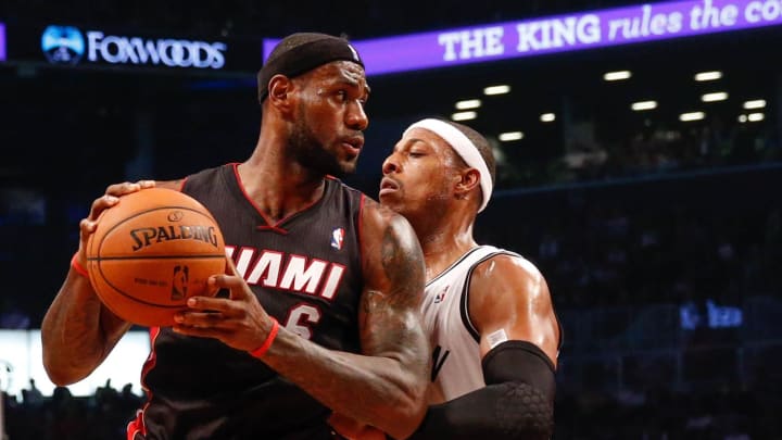 Oct 17, 2013; Brooklyn, NY, USA;  Brooklyn Nets small forward Paul Pierce (34) holds off Miami Heat small forward LeBron James (6) during the first quarter at Barclays Center. Mandatory Credit: Anthony Gruppuso-USA TODAY Sports
