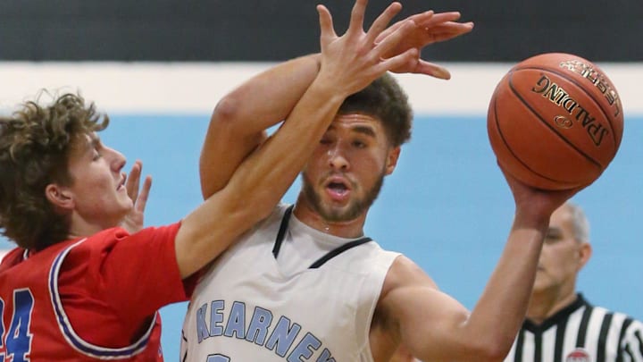 Bishop Kearney's Alejandro Aguilar, pictured from an earlier game, hit a three-quarter shot in the final second of the fourth quarter, Monday, to lift his team into overtime against Aquinas Institute. Kearney eventually lost, 85-75. Bishop Kearney's Alejandro Aguilar, pictured from an earlier game, hit a three-quarter shot in the final second of the fourth quarter, Monday, to lift his team into overtime against Aquinas Institute. Kearney eventually lost, 85-75.