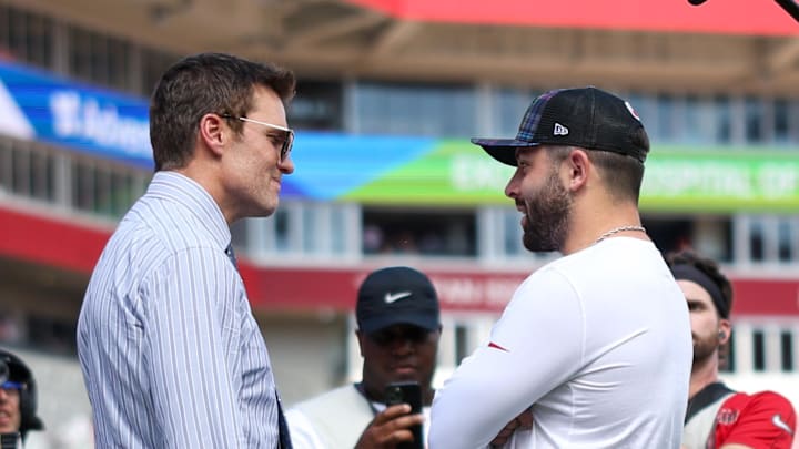 Sep 29, 2024; Tampa, Florida, USA; Fox NFL broadcaster and former NFL quarterback Tom Brady speaks to Tampa Bay Buccaneers quarterback Baker Mayfield (6) before a game against the Philadelphia Eagles at Raymond James Stadium. Mandatory Credit: Nathan Ray Seebeck-Imagn Images