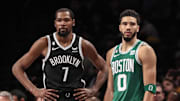 Dec 4, 2022; Brooklyn, New York, USA;  Brooklyn Nets forward Kevin Durant (7) and Boston Celtics forward Jayson Tatum (0) during a time out in the fourth quarter at Barclays Center. Mandatory Credit: Wendell Cruz-Imagn Images