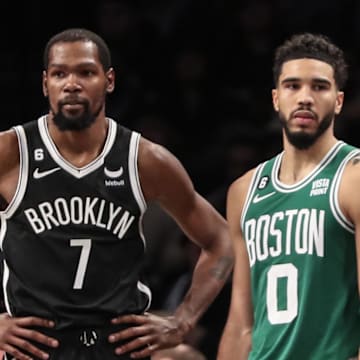 Dec 4, 2022; Brooklyn, New York, USA;  Brooklyn Nets forward Kevin Durant (7) and Boston Celtics forward Jayson Tatum (0) during a time out in the fourth quarter at Barclays Center. Mandatory Credit: Wendell Cruz-Imagn Images