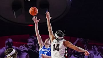 Jan 7, 2025; Athens, Georgia, USA; Kentucky Wildcats forward Andrew Carr (7) shoots over Georgia Bulldogs forward Asa Newell (14) during the first half at Stegeman Coliseum. Mandatory Credit: Dale Zanine-Imagn Images