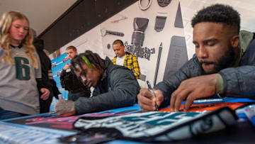 Philadelphia Eagles CJ Gardner Johnson, left, and Boston Scott sign items for fans, during a rally for their Super Bowl team, held at the Oxford Valley Mall, in Middletown, on Saturday, Feb. 4, 2023.

Cot Eagles At Mall 17