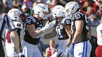 Dec 23, 2023; Birmingham, AL, USA; Duke Blue Devils tight end Cole Finney (82) and offensive linemen Brian Parker II (53) react with tight end Nicky Dalmolin (81) after a successful two point conversion during the first half against the Troy Trojans at Protective Stadium. 