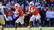 Oct 4, 2025; Blacksburg, Virginia, USA;  Virginia Tech Hokies quarterback Kyron Drones (1) hands the ball to running back Marcellous Hawkins (27) against the Wake Forest Demon Deacons during the third quarter at Lane Stadium. Mandatory Credit: Brian Bishop-Imagn Images