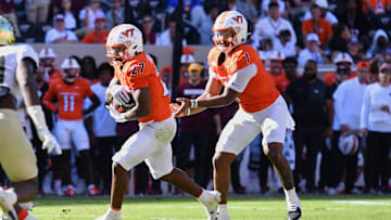 Oct 4, 2025; Blacksburg, Virginia, USA;  Virginia Tech Hokies quarterback Kyron Drones (1) hands the ball to running back Marcellous Hawkins (27) against the Wake Forest Demon Deacons during the third quarter at Lane Stadium. Mandatory Credit: Brian Bishop-Imagn Images