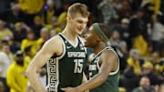Michigan State Spartans center Carson Cooper (15) and guard Tre Holloman (5) react 