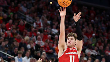 Mar 16, 2024; Minneapolis, MN, USA; Wisconsin Badgers guard Max Klesmit (11) shoots as Purdue Boilermakers guard Fletcher Loyer (2) defends during the second half at Target Center. Mandatory Credit: Matt Krohn-Imagn Images