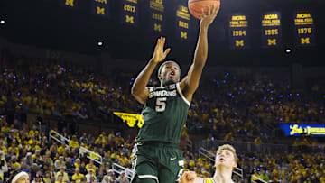 Feb 21, 2025; Ann Arbor, Michigan, USA; Michigan State Spartans guard Tre Holloman (5) goes to the basket during the second half against the Michigan Wolverines at Crisler Center. Mandatory Credit: Brian Bradshaw Sevald-Imagn Images