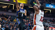Dec 12, 2022; Indianapolis, Indiana, USA; Indiana Pacers guard Tyrese Haliburton (0) shoots the ball while Miami Heat center Bam Adebayo (13) defends in the first quarter at Gainbridge Fieldhouse. Mandatory Credit: Trevor Ruszkowski-Imagn Images