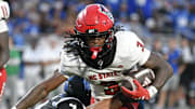 Sep 20, 2025; Durham, North Carolina, USA;  North Carolina State Wolfpack running back Hollywood Smothers (3) is tackled by Duke Blue Devils running back Anderson Castle (4) during the fourth quarter  at Wallace Wade Stadium. Mandatory Credit: Zachary Taft-Imagn Images