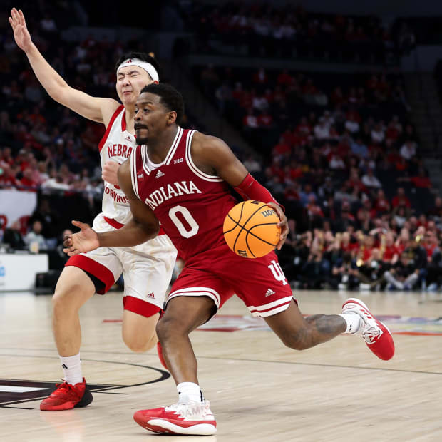 Mar 15, 2024; Minneapolis, MN, USA; Indiana Hoosiers guard Xavier Johnson (0) works around Nebraska Cornhuskers guard Keisei 