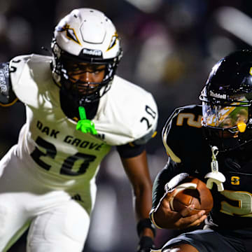 Kingston Johnson evades the Oak Grove defender in their 57-54 win on August 29.