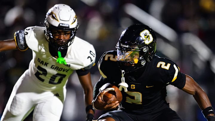 Kingston Johnson evades the Oak Grove defender in their 57-54 win on August 29.