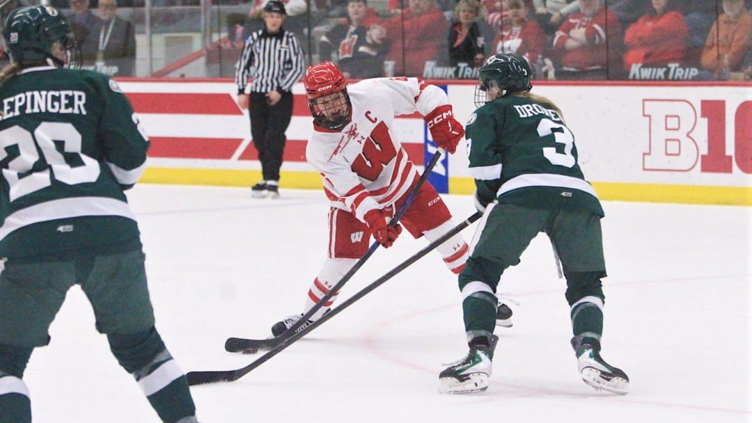 Wisconsin's Lacey Eden (6) prepares to take a shot as Bemidji State's Olivia Dronen defends during a WCHA first -round playoff game Saturday Feb. 28, 2026 at LaBahn Arena in Madison, Wis. Wisconsin won, 3-2, in overtime.