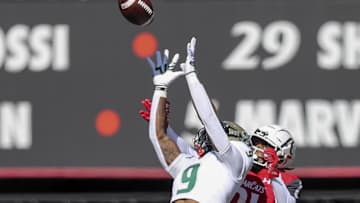 South Florida Bulls defensive back Aamaris Brown (9) intercepts the ball intended for Cincinnati Bearcats wide receiver Tyler Scott (21) in the first half at Nippert Stadium. Mandatory Credit: Katie Stratman-Imagn Images
