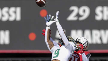 Oct 8, 2022; Cincinnati, Ohio, USA; South Florida Bulls defensive back Aamaris Brown (9) intercepts the ball intended for Cincinnati Bearcats wide receiver Tyler Scott (21) in the first half at Nippert Stadium. Mandatory Credit: Katie Stratman-Imagn Images