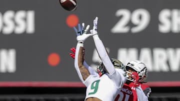South Florida Bulls defensive back Aamaris Brown (9) intercepts the ball intended for Cincinnati Bearcats wide receiver Tyler Scott (21) in the first half at Nippert Stadium. Mandatory Credit: Katie Stratman-Imagn Images
