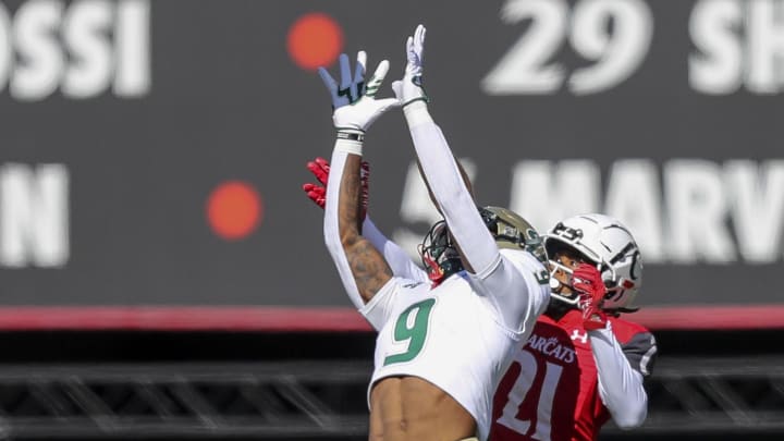 Oct 8, 2022; Cincinnati, Ohio, USA; South Florida Bulls defensive back Aamaris Brown (9) intercepts the ball intended for Cincinnati Bearcats wide receiver Tyler Scott (21) in the first half at Nippert Stadium. Mandatory Credit: Katie Stratman-USA TODAY Sports