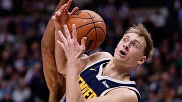 Feb 12, 2025; Denver, Colorado, USA; Denver Nuggets forward Hunter Tyson (5) battles for a rebound with Portland Trail Blazers guard Rayan Rupert (21) in the third quarter at Ball Arena. Mandatory Credit: Isaiah J. Downing-Imagn Images