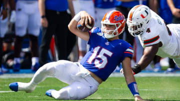 Florida Gators quarterback Graham Mertz (15) slides during a play while being pursued by Miami Hurricanes defensive lineman Rueben Bain Jr. (4) uring the season opener at Ben Hill Griffin Stadium in Gainesville, FL on Saturday, August 31, 2024 against the University of Miami Hurricanes in the first half. [Doug Engle/Gainesville Sun]