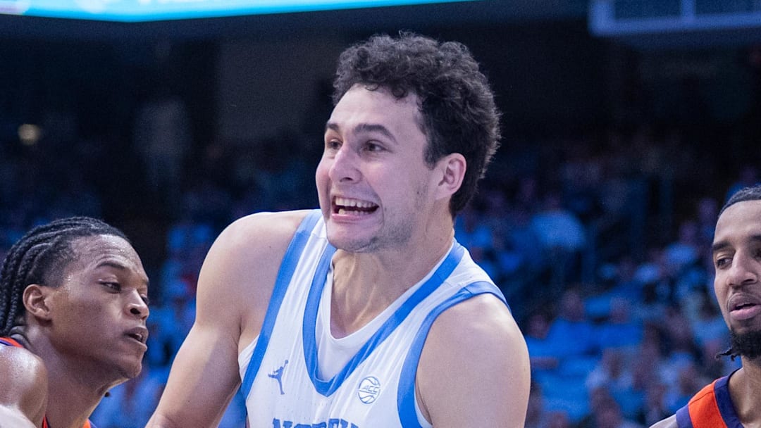 Mar 3, 2026; Chapel Hill, North Carolina, USA; Clemson Tigers forward RJ Godfrey (0) ties up the ball with North Carolina Tar Heels guard Luka Bogavac (44) during the second half at Dean E. Smith Center. Mandatory Credit: Scott Kinser-Imagn Images