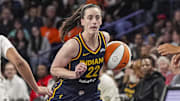 May 10, 2025; Atlanta, GA, USA; Indiana Fever guard Caitlin Clark (22) dribbles against Atlanta Dream guard Te-Hina Paopao (2) during the second half at Gateway Center Arena @ College Park. Mandatory Credit: Dale Zanine-Imagn Images