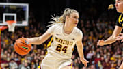 Feb 28, 2024; Minneapolis, Minnesota, USA; Minnesota Golden Gophers forward Mallory Heyer (24) dribbles as Iowa Hawkeyes guard Kate Martin (20) defends during the first half at Williams Arena. Mandatory Credit: Matt Krohn-Imagn Images