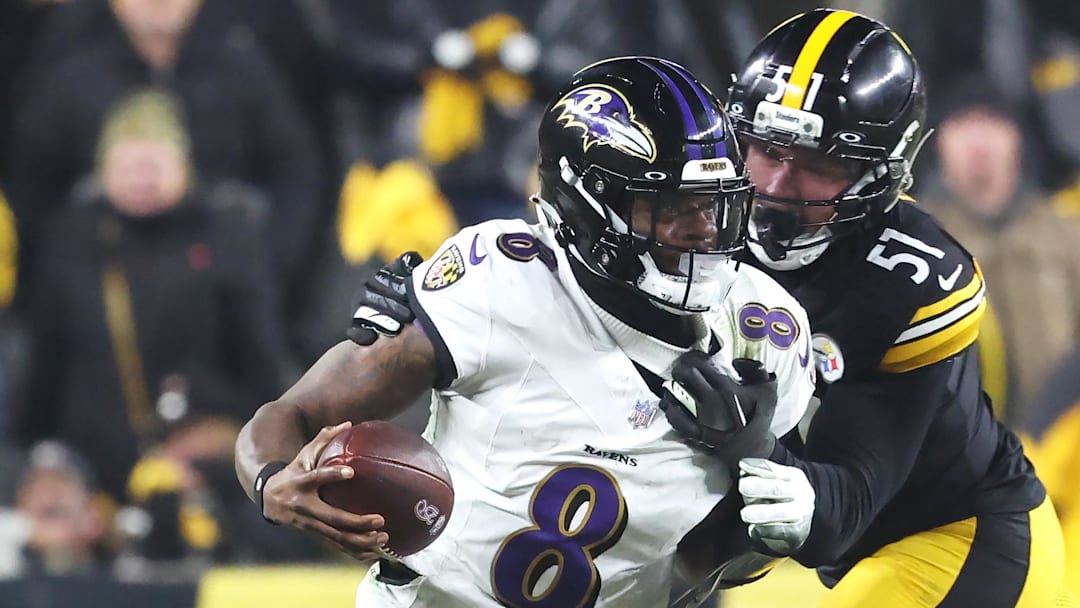 Jan 4, 2026; Pittsburgh, Pennsylvania, USA;  Baltimore Ravens quarterback Lamar Jackson (8) scrambles with the ball as Pittsburgh Steelers linebacker Nick Herbig (51) cases during the fourth quarter at Acrisure Stadium. Mandatory Credit: Charles LeClaire-Imagn Images