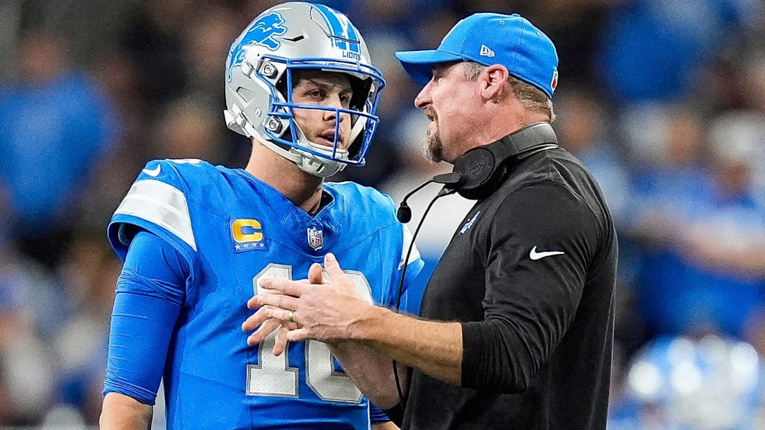 Detroit Lions quarterback Jared Goff (16) talks to head coach Dan Campbell before a play against the Green Bay Packers during the second half at Ford Field in Detroit on Thursday, Dec. 5, 2024.