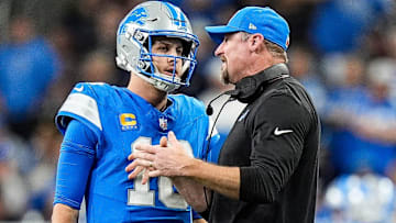 Detroit Lions quarterback Jared Goff (16) talks to head coach Dan Campbell before a play against the Green Bay Packers during the second half at Ford Field in Detroit on Thursday, Dec. 5, 2024.