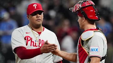 Philadelphia Phillies relief pitcher Carlos Hernandez (35) and catcher J.T. Realmuto (10) celebrate defeating the Colorado Rockies at Coors Field.