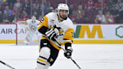 Sep 22, 2025; Montreal, Quebec, CAN; Pittsburgh Penguins forward Robby Fabbri (12) plays the puck and Montreal Canadiens forward Lucas Condotta (82) defends during the first period at the Bell Centre. Mandatory Credit: Eric Bolte-Imagn Images