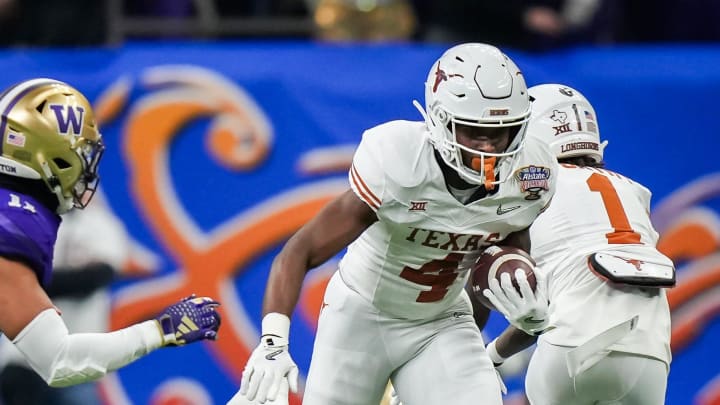 Texas Longhorns running back CJ Baxter (4) evades the Washington defense to carry the ball during the Sugar Bowl College Football Playoff semi-finals at the Ceasars Superdome in New Orleans, Louisiana, Jan. 1, 2024. The Huskies won the game over the Longhorns 37-31.