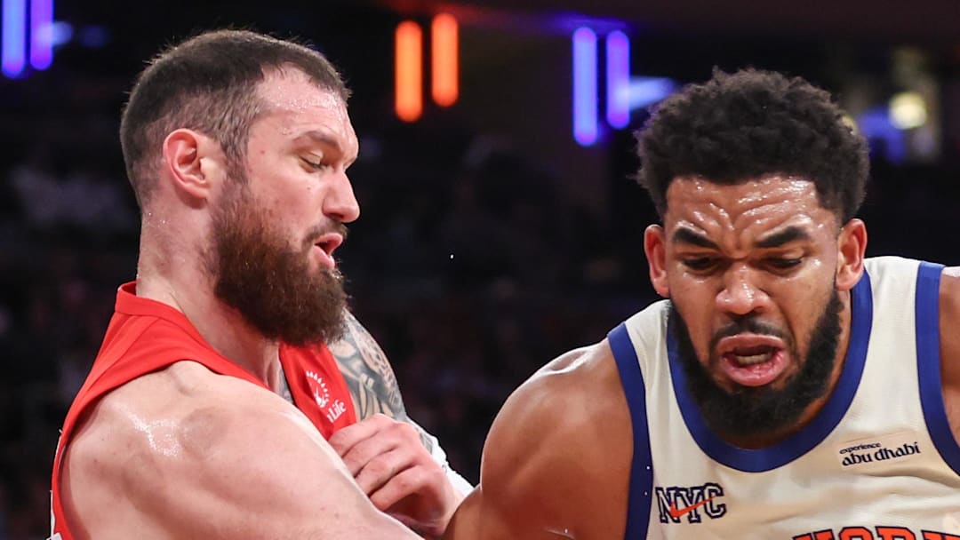 New York Knicks center Karl-Anthony Towns looks to post up against Toronto Raptors forward Sandro Mamukelashvili.
