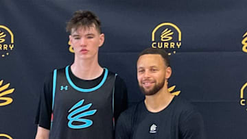 Quinn Costello next to Steph Curry at the 2025 Curry Camp. 